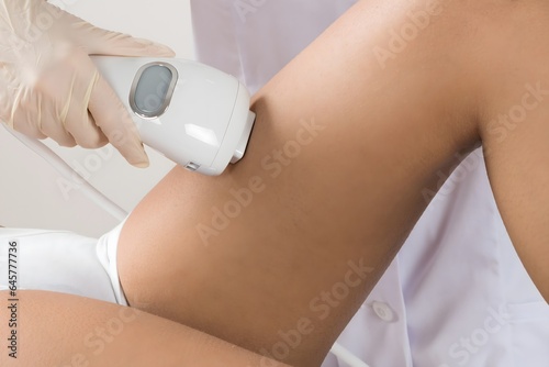 Person Giving Laser Therapy To Woman