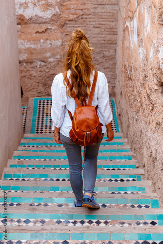 Woman walking in Marrakesh streets- Morocco © M.studio