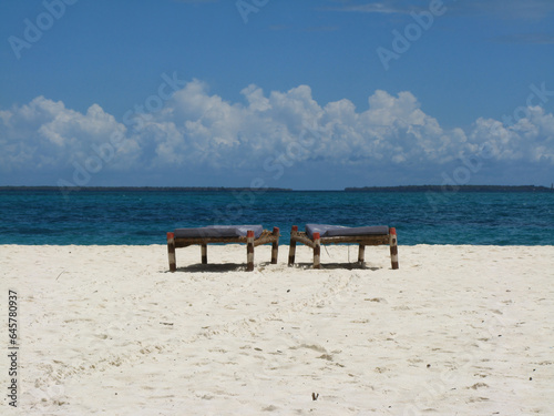 View from Kendwa beach  Zanzibar  Tanzania  on two sunbeds and horizon in the background