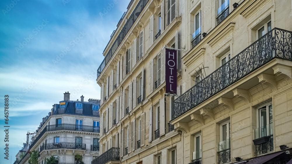 Paris, typical facade, beautiful building in the center with an hotel sign
Paris, typical facade, beautiful building in the center with an hotel sign