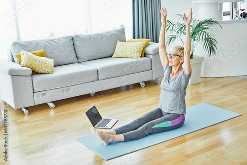 senior active exercise training sport fitness home stretching woman elderly pilates gym yoga indoorlaptop online instructions healthy recovery