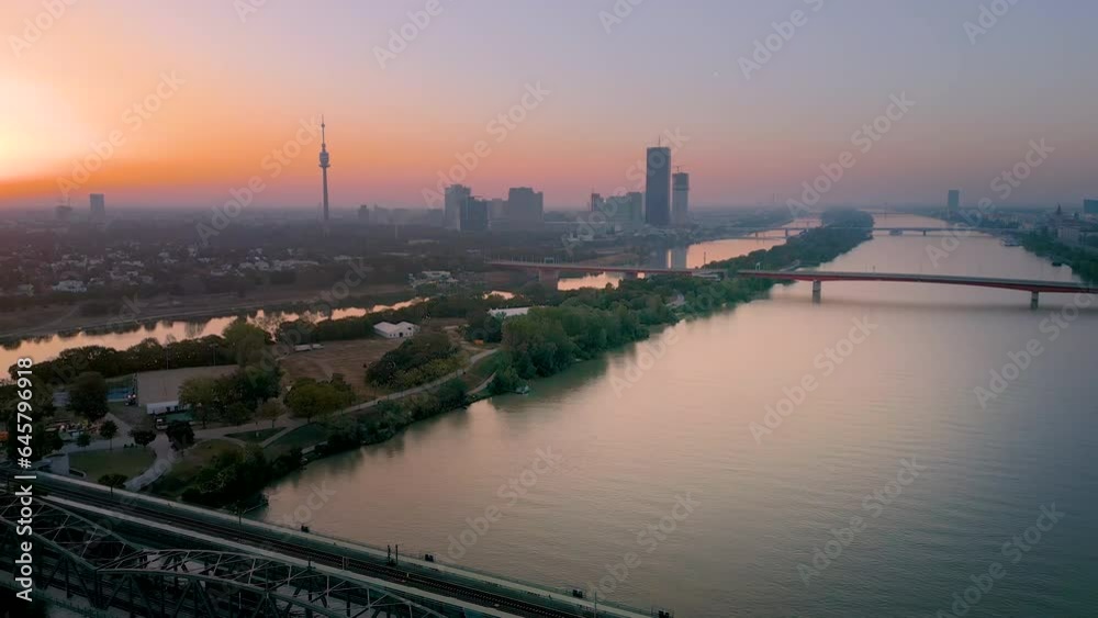 Vienna skyline aerial view drone footage view at sunrise vienna austria city fly over brdige and river in front skyscrapers.