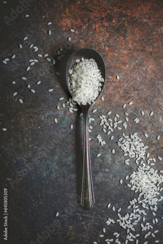 Top View of a  Spoon of Uncooked Arborio Rice on Dark Background