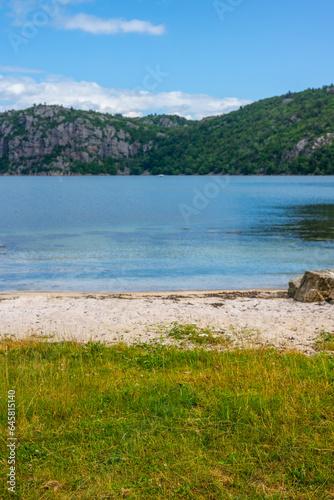 Small sand beach by a fjord.