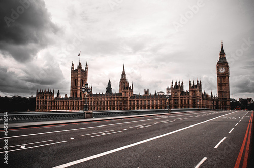 London  Great Britain - July 18  2012  Empty Westminster Bridge with clock tower and Big Ben. Parliament building with flag and rainy clouds.