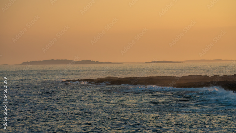 Vibrant coastal sunset paints the sky in hues of orange and purple, casting a warm glow on the rugged rocky shore, a tranquil moment captured in nature's artistry. Vibrant coastal sunset paints the sky in hues of orange and purple, casting a warm glow on the rugged rocky shore, a tranquil moment captured in nature's artistry.