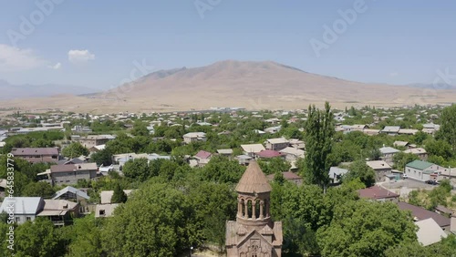 Backward reveal drone shot of Surb Astvatsatsin (Holy Mother of God) Church on sunny day. Yeghvard, Armenia. photo