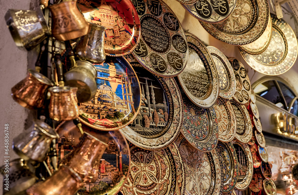 Istanbul, Turkey - July 22,2023: Close up metal plates with engravings at a street vendor in Istanbul’s Grand Bazaar
