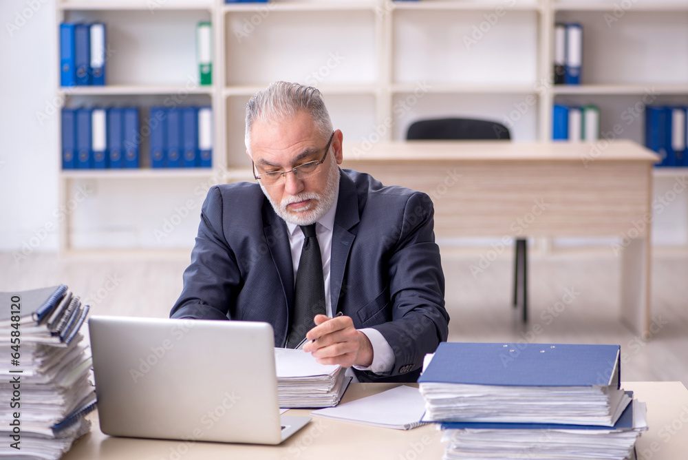 Old male employee and too much work at workplace Old male employee and too much work at workplace