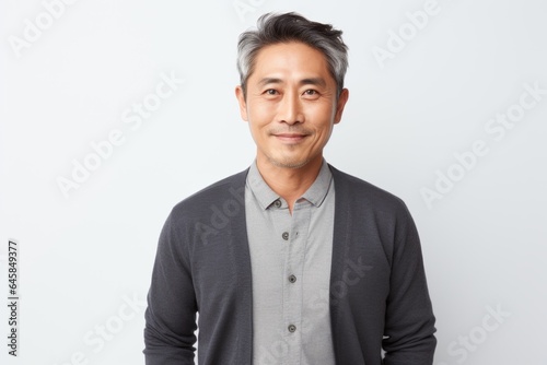 Portrait photography of a Vietnamese man in his 40s against a white background