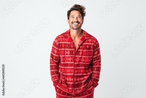 Portrait photography of a Peruvian man in his 30s wearing a snuggly pajama set against a white background
