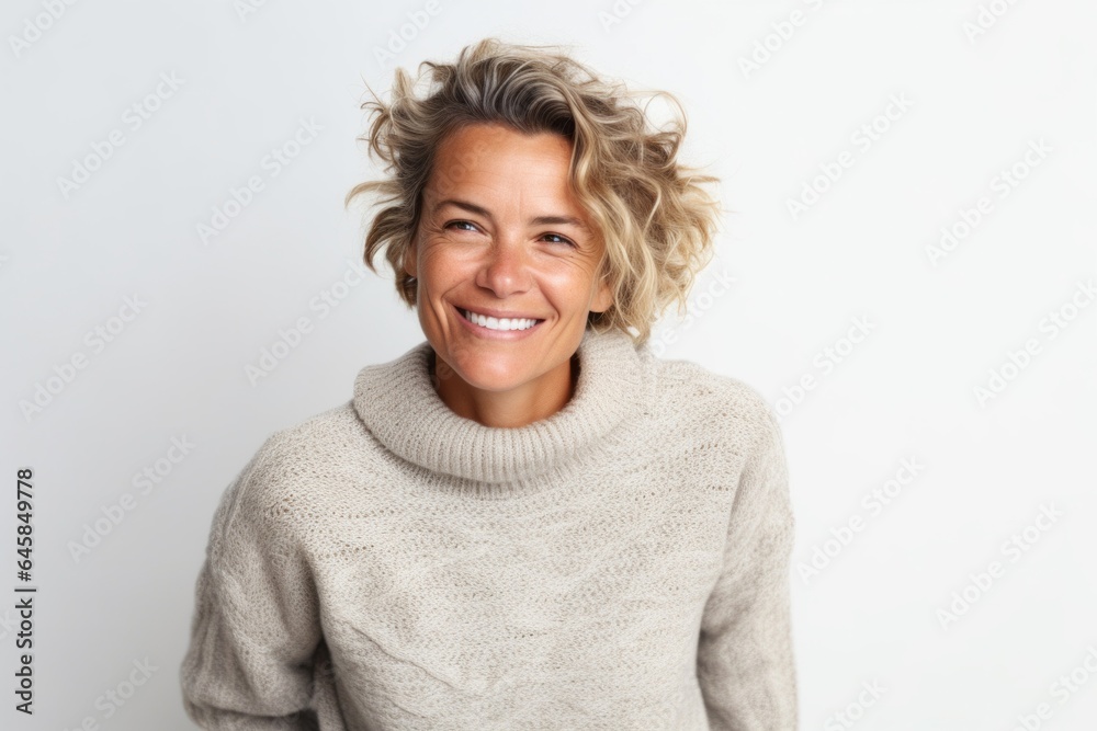 Portrait photography of a French woman in her 40s wearing a cozy sweater against a white background Portrait photography of a French woman in her 40s wearing a cozy sweater against a white background