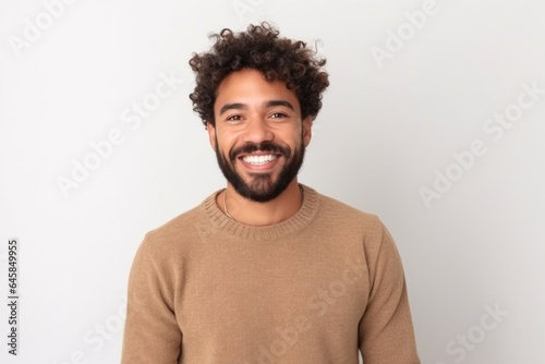 Medium shot portrait photography of a Colombian man in his 20s against a white background