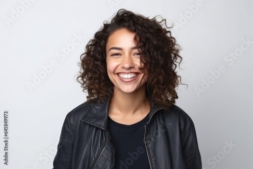 Medium shot portrait photography of a Colombian woman in her 30s wearing a denim jacket against a white background