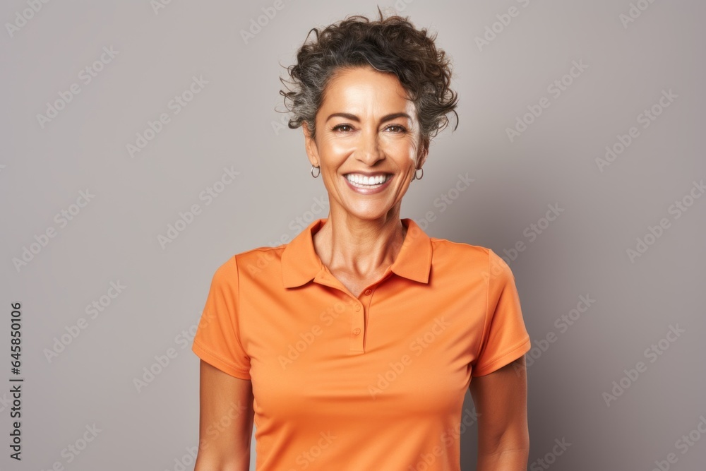 Portrait photography of a Colombian woman in her 50s wearing a sporty polo shirt against a white background Portrait photography of a Colombian woman in her 50s wearing a sporty polo shirt against a white background