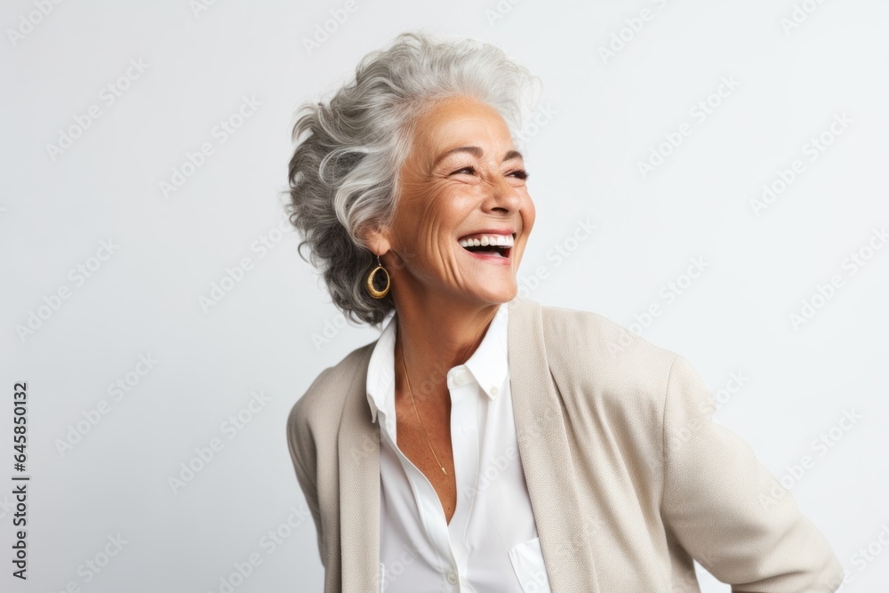 Portrait photography of a Colombian woman in her 60s wearing a classic blazer against a white background Portrait photography of a Colombian woman in her 60s wearing a classic blazer against a white background