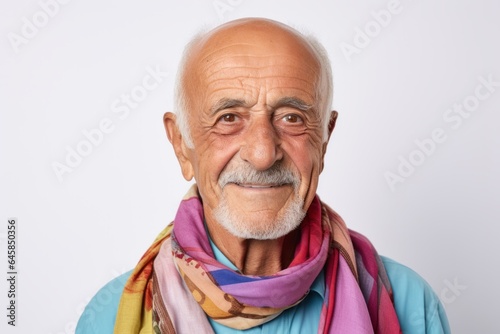 Portrait photography of a Italian man in his 80s wearing a foulard against a white background