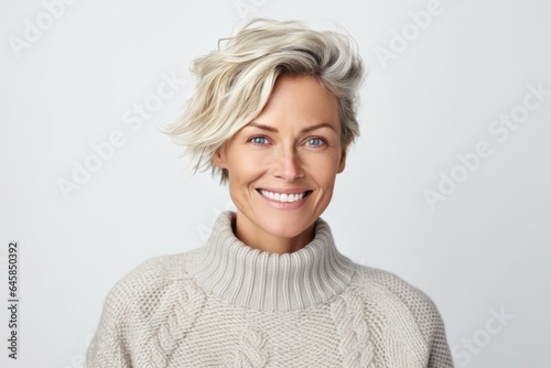 Medium shot portrait photography of a Swedish woman in her 30s wearing a cozy sweater against a white background © Anne Schaum