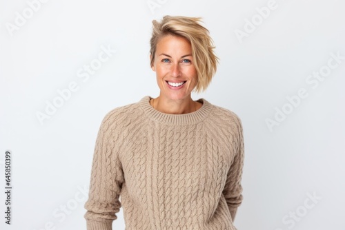 Portrait photography of a Swedish woman in her 30s wearing a cozy sweater against a white background
