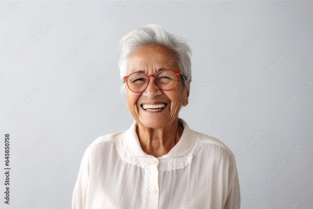 Medium shot portrait photography of a 100-year-old elderly Colombian woman against a minimalist or empty room background Medium shot portrait photography of a 100-year-old elderly Colombian woman against a minimalist or empty room background