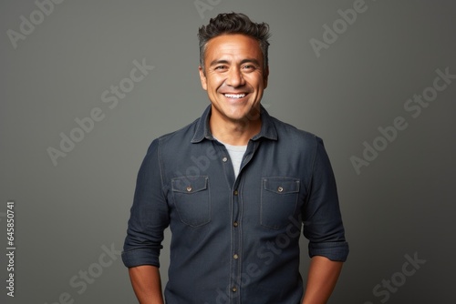 Lifestyle portrait photography of a Colombian man in his 40s against a minimalist or empty room background