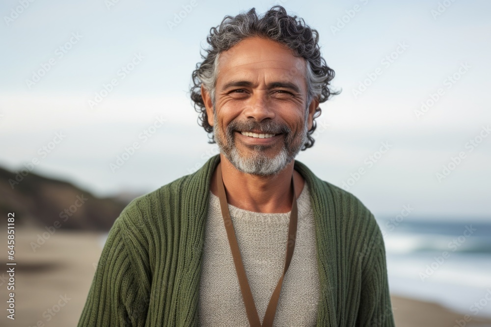 Medium shot portrait photography of a Colombian man in his 50s against a beach background Medium shot portrait photography of a Colombian man in his 50s against a beach background