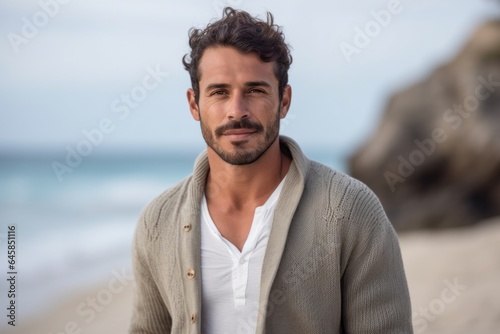 Medium shot portrait photography of a serious Colombian man in his 30s against a beach background