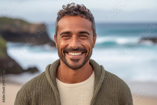 Close-up portrait photography of a Colombian man in his 30s against a beach background