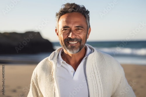 Medium shot portrait photography of a Colombian man in his 50s against a beach background