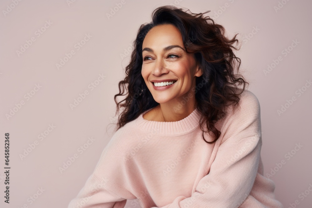 Portrait photography of a Peruvian woman in her 40s wearing a cozy sweater against a pastel or soft colors background Portrait photography of a Peruvian woman in her 40s wearing a cozy sweater against a pastel or soft colors background