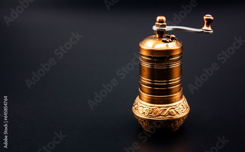 Photograph of an ancient, handcrafted coffee grinder.