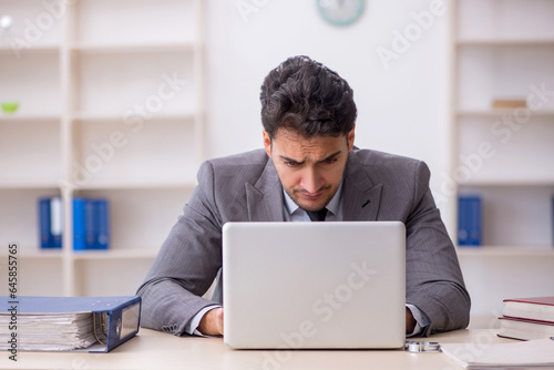 Young male employee working in the office