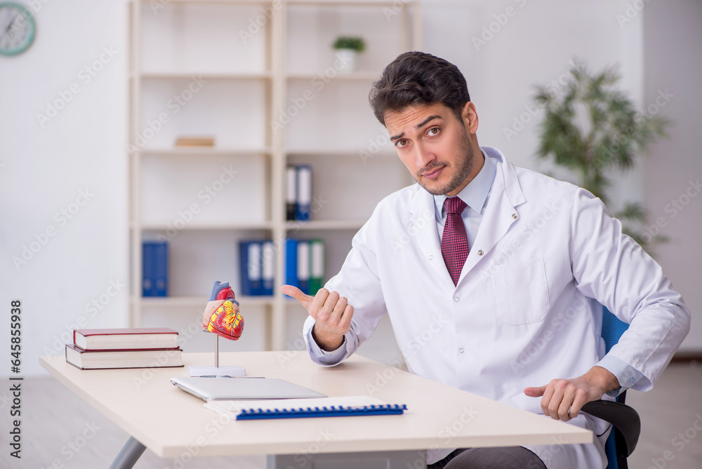 Young male doctor cardiologist working in the clinic Young male doctor cardiologist working in the clinic