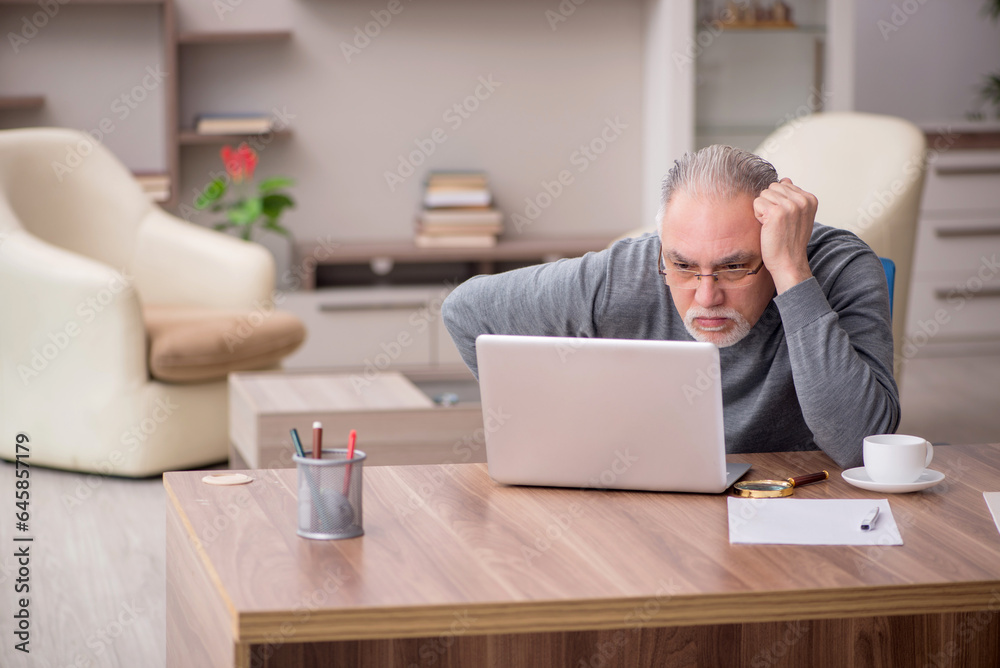Old male employee working from home during pandemic Old male employee working from home during pandemic