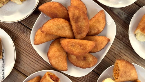 Tabletop view of various empanada dishes photo