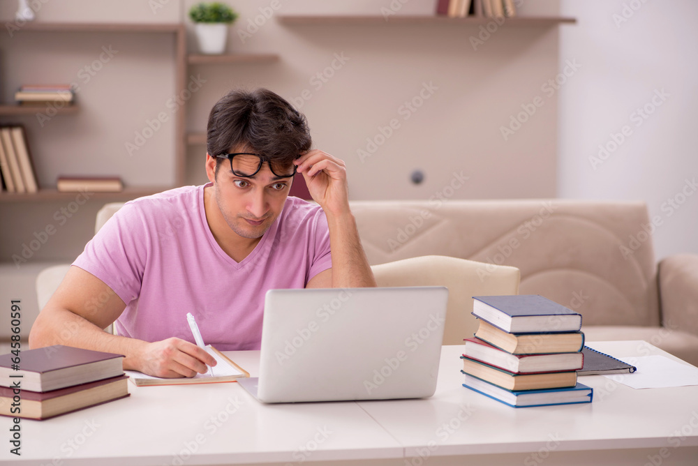 Young male student preparing for exams at home Young male student preparing for exams at home