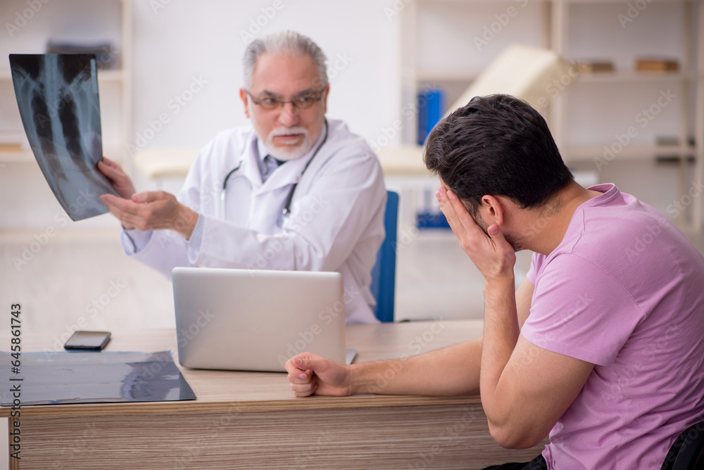 Young male patient visiting old male doctor radiologist