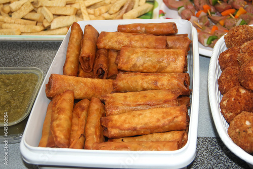 Fried springs rolls in a white bowl. Spring rolls