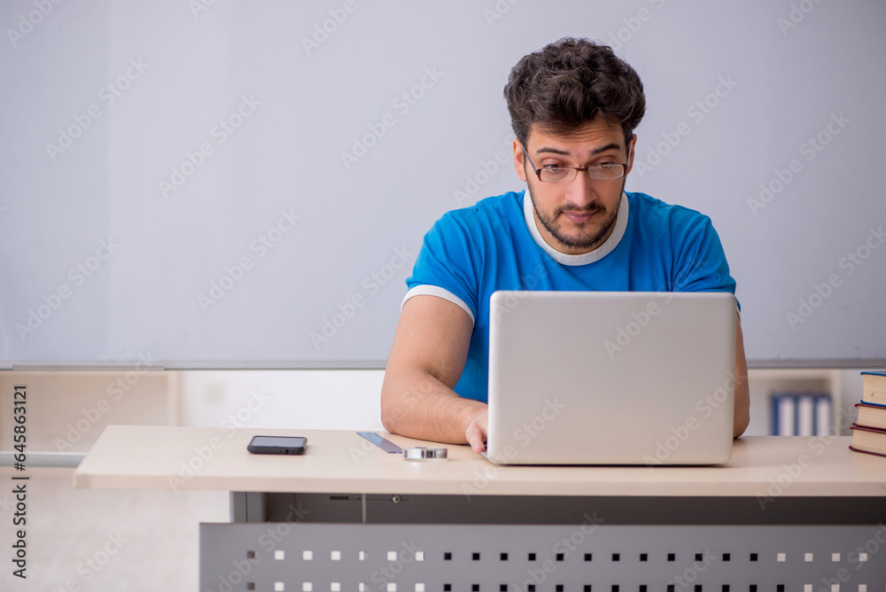 Young male student in telestudying concept