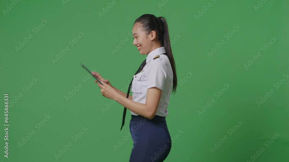 Side View Of Asian Woman Pilot Using A Tablet While Walking In The Green Screen Background Studio
Side View Of Asian Woman Pilot Using A Tablet While Walking In The Green Screen Background Studio