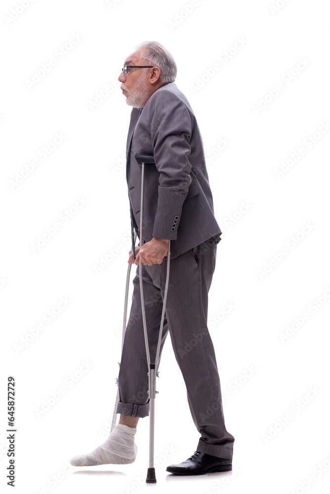 Old businessman with crutches isolated on white Old businessman with crutches isolated on white