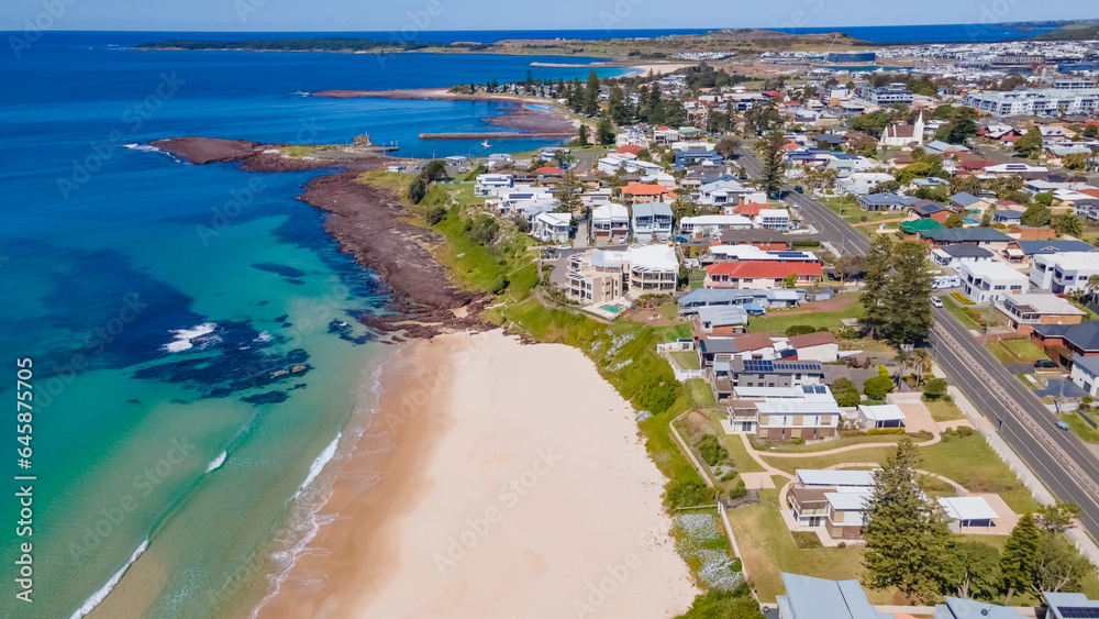 Aerial drone view of Shellharbour above Shellharbour North Beach on the New South Wales South Coast, Australia looking in the south direction toward Shell Cove on a sunny day 