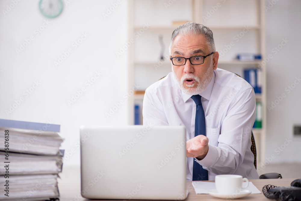 Old male employee and too much work in the office Old male employee and too much work in the office