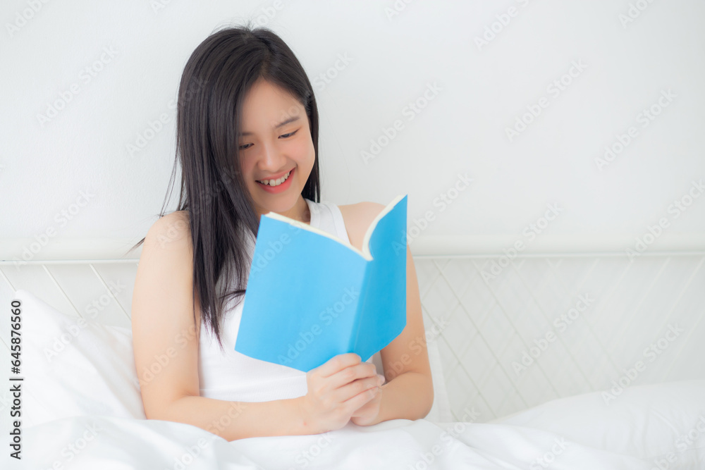 Young asian woman reading a book with relax and cozy on the bed in the bedroom at home, female leisure reading novel while resting with emotional positive, one person, lifestyles concept. Young asian woman reading a book with relax and cozy on the bed in the bedroom at home, female leisure reading novel while resting with emotional positive, one person, lifestyles concept.