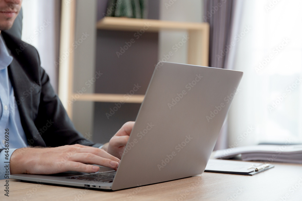 Hands young caucasian businessman using laptop computer planning for success in modern office, businessman typing on notebook doing marketing, executive or manager with handsome, business concept. Hands young caucasian businessman using laptop computer planning for success in modern office, businessman typing on notebook doing marketing, executive or manager with handsome, business concept.