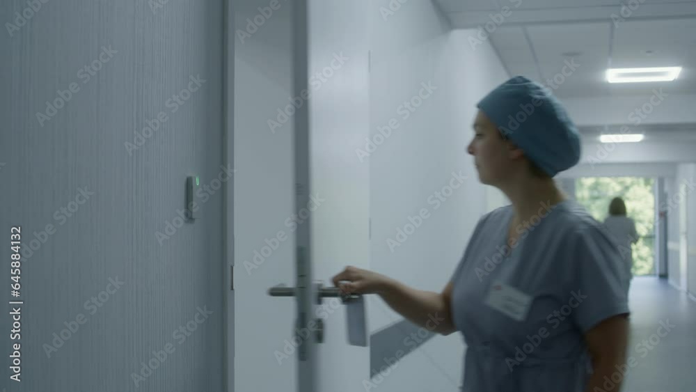 Nurse opens door to operating room with key card in hospital corridor. Doctor pushes elderly patient on wheelchair in cabinet for medical procedures. Medical staff in modern clinic or medical center. Nurse opens door to operating room with key card in hospital corridor. Doctor pushes elderly patient on wheelchair in cabinet for medical procedures. Medical staff in modern clinic or medical center.