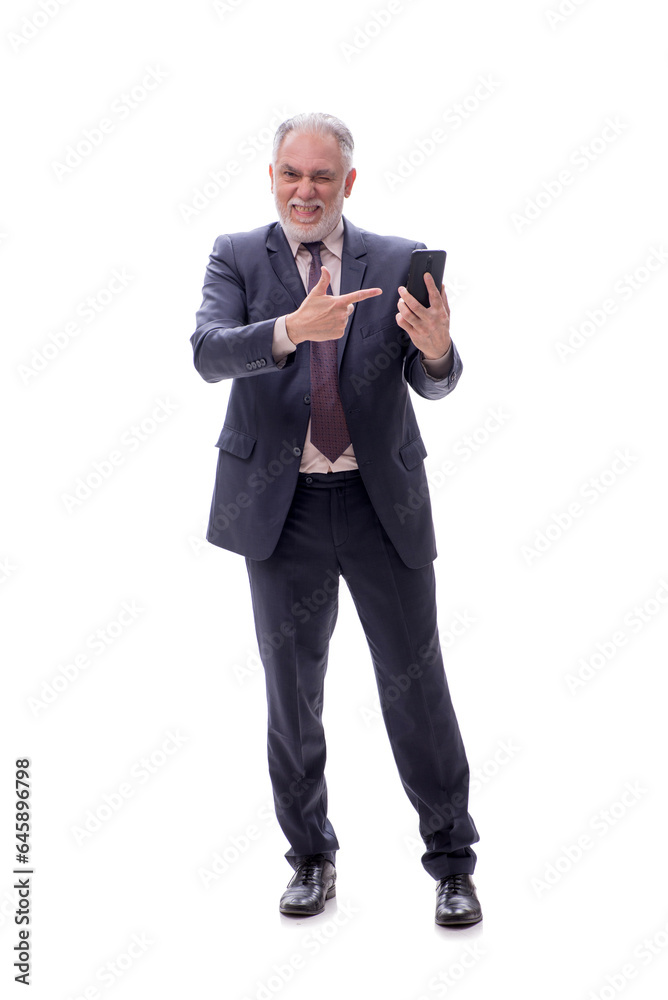 Old businessman talking by phone isolated on white