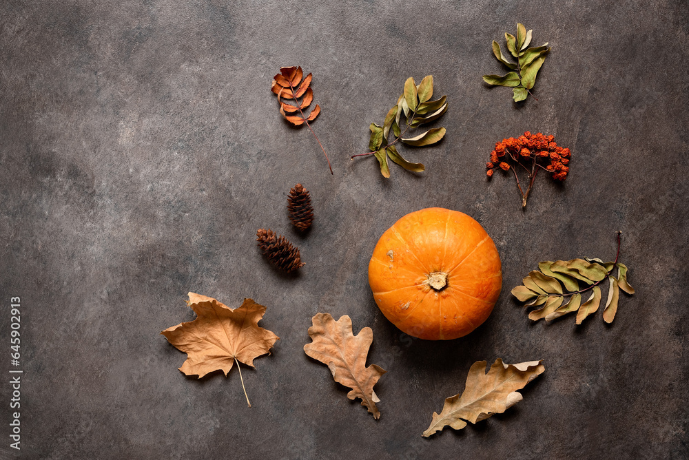 Fototapeta premium Autumn background with pumpkin and dried leaves. Top view, flat lay.