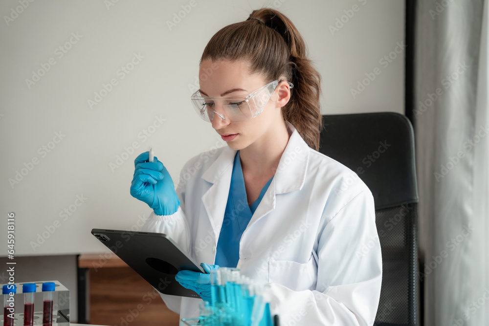 Chemist scientist holding test tube and tablet conducting experiment in laboratory with equipment, science concept. Chemist scientist holding test tube and tablet conducting experiment in laboratory with equipment, science concept.