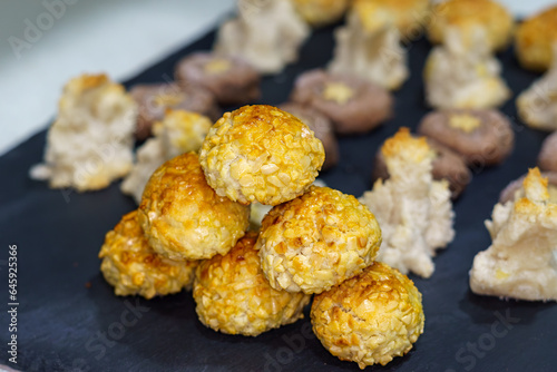 Panellets, a traditional sweet from Catalonia, Spain, prepared to be eaten on November 1, All Saints' Day. Sweet dough made with sugar, ground raw almonds, egg, sugar, sugared almonds, egg photo
